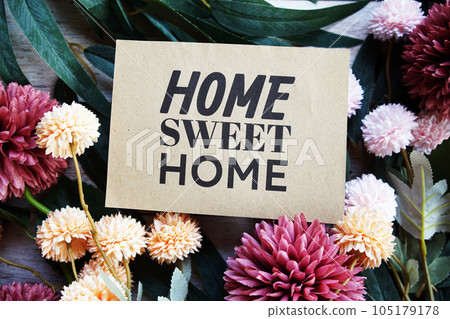 Home Sweet Home text message with flower decoration on wooden background Home Sweet Home text message with flower decoration on wooden background 105179178