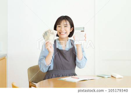 Photo of a smiling woman holding cash 105179340