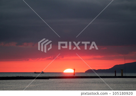 The sun setting over the Sea of Japan off the coast of Godzilla Rock on the Oga Peninsula 105180920