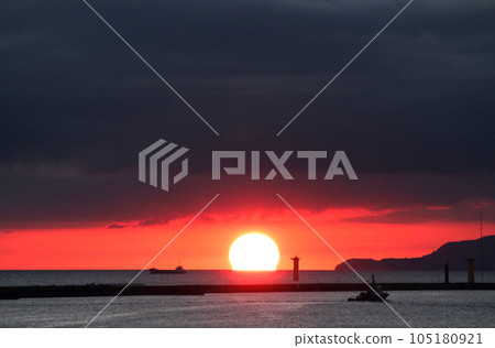 The sun setting over the Sea of Japan off the coast of Godzilla Rock on the Oga Peninsula The sun setting over the Sea of Japan off the coast of Godzilla Rock on the Oga Peninsula 105180921