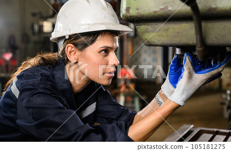 Confident female technician engineer worker checking and inspecting machine  105181275