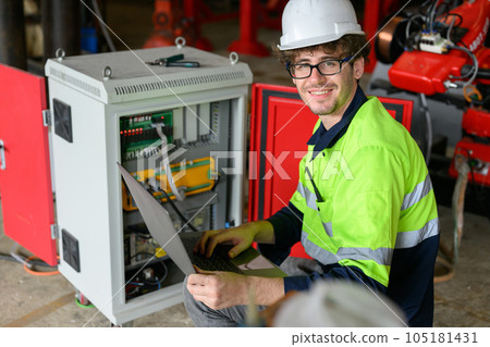 Professional male technician worker in white helmet checking machine maintenance Professional male technician worker in white helmet checking machine maintenance 105181431