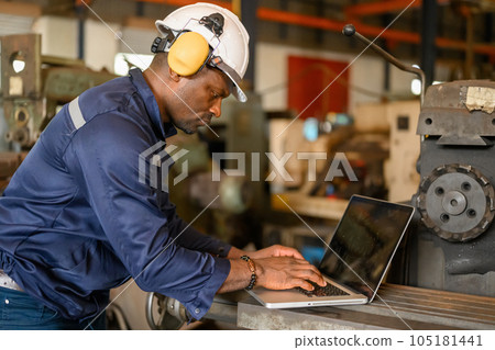 Male technician specialist with safety uniform using laptop Male technician specialist with safety uniform using laptop 105181441