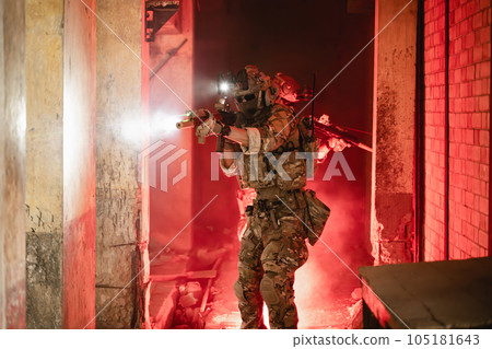 Expert team of soldiers attacking enemy during military operation, Army soldiers in protective combat uniform, Soldiers with rifle on world war field 105181643
