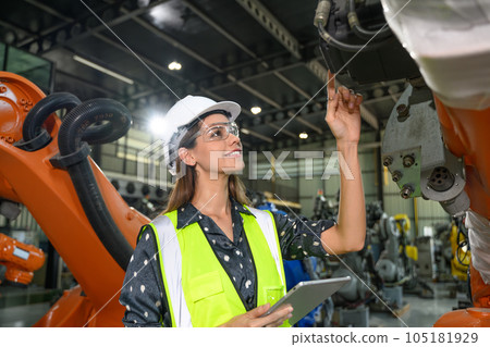 Female business owner engineer managing and checking work at factory Female business owner engineer managing and checking work at factory 105181929