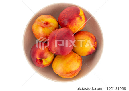 Fresh nectarines fruits in bowl isolated on white background. Ripe peach top view. Fresh nectarines fruits in bowl isolated on white background. Ripe peach top view. 105181968