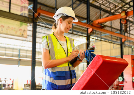 Mechanical engineers repairing engine machine at factory 105182052