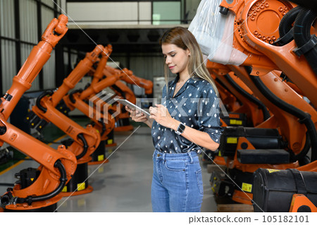 Female business owner engineer managing and checking work at factory 105182101