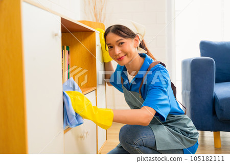 Happy woman cleaning house, Housekeeping and cleaning service, People doing housework at home 105182111