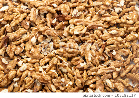 Closeup of big shelled walnuts pile. Nuts are a source of vegetable protein. 105182137