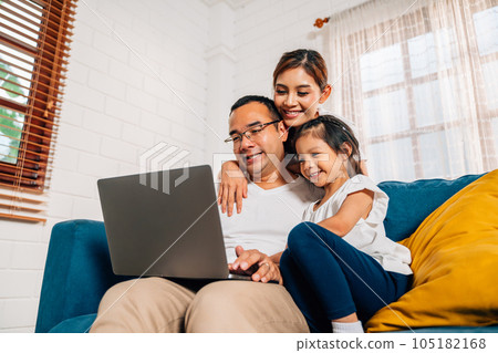 Family father mother and daughter using laptop and surfing internet 105182168