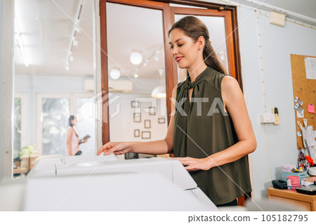 Confident secretary using modern printer and working at company 105182795