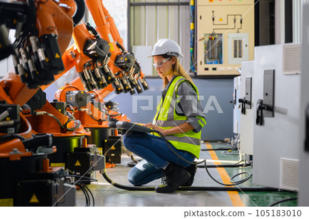 Female engineer worker working with robotic machine automation 105183010