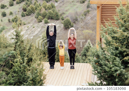 Happy family are stretching outdoors 105183098