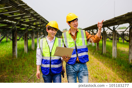 Maintenance engineer checking solar panels on solar cell farm Maintenance engineer checking solar panels on solar cell farm 105183277