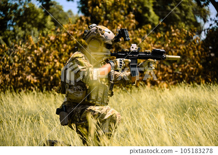 Army soldier in protective combat uniform, Soldier with rifle in forest, Soldier on duty, Military soldier shooting with assault rifle on world war field Army soldier in protective combat uniform, Soldier with rifle in forest, Soldier on duty, Military soldier shooting with assault rifle on world war field 105183278