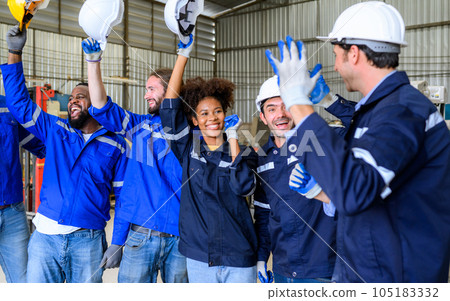 Group of happy engineers workers team smiling and standing at factory 105183332