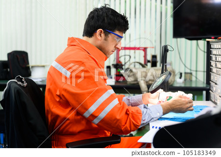 Engineer with safety uniform working and repairing machine Engineer with safety uniform working and repairing machine 105183349
