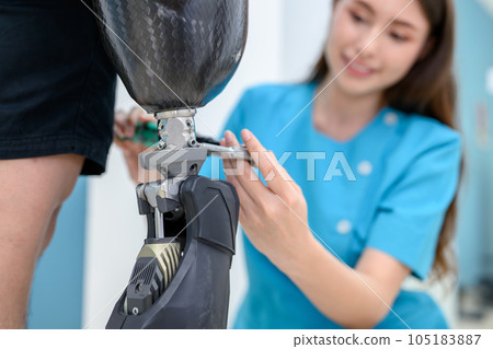 Female physiotherapist adjusting prosthetic leg of patient in hospital Female physiotherapist adjusting prosthetic leg of patient in hospital 105183887