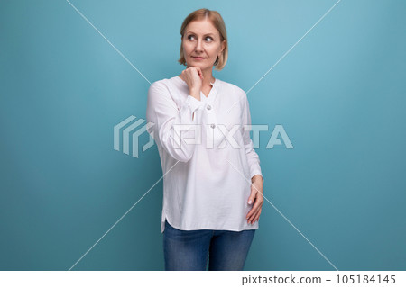 pensive slender blondie middle-aged woman in a white blouse pensive slender blondie middle-aged woman in a white blouse 105184145