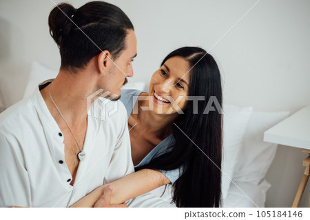 Happy young couple of husband and wife spending time together at home, People relaxing and resting at modern house, Family and lovers lifestyle Happy young couple of husband and wife spending time together at home, People relaxing and resting at modern house, Family and lovers lifestyle 105184146