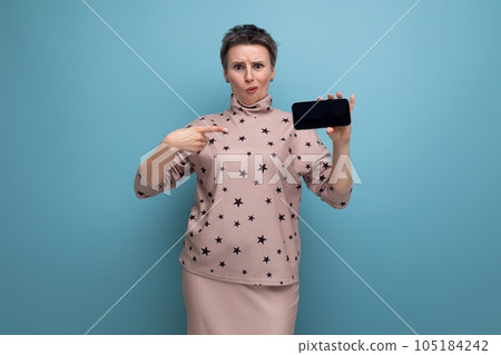 successful 30 year old european woman with dyed gray hair in skirt and blouse showing smartphone 105184242