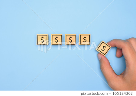 financial icon on wooden block. financial symbol on wooden with clean background. High quality photo financial icon on wooden block. financial symbol on wooden with clean background. High quality photo 105184302