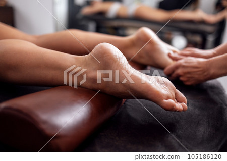 Close up of female foot getting gentle massage Close up of female foot getting gentle massage 105186120