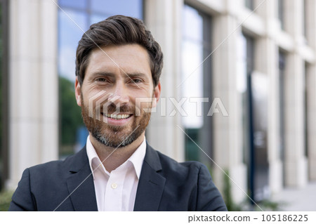 Boss man looking at camera and smiling, young businessman banker with beard photo with close up portrait. Boss man looking at camera and smiling, young businessman banker with beard photo with close up portrait. 105186225