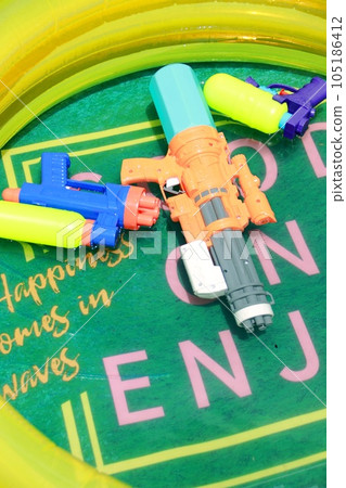 A water gun floating on the surface of the vinyl pool A water gun floating on the surface of the vinyl pool 105186412
