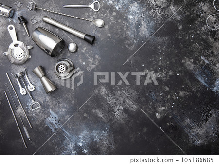 Various bar cocktail stainless steel utensils set on black background. 105186685