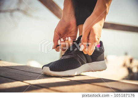 feet running on road closeup on shoe 105187176