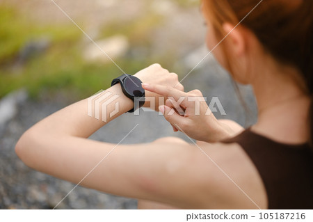 Burning calories. Cropped closeup of a fit woman looking at her smart watch counting burned calories during her workout at the gym. Woman using fitness bracelet copyspace Burning calories. Cropped closeup of a fit woman looking at her smart watch counting burned calories during her workout at the gym. Woman using fitness bracelet copyspace 105187216