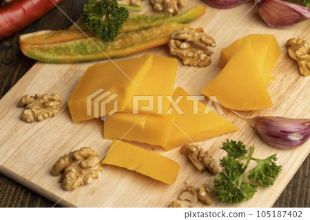 Sliced hard cheese made from milk Sliced hard cheese made from milk 105187402
