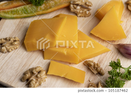 Sliced hard cheese made from milk Sliced hard cheese made from milk 105187462