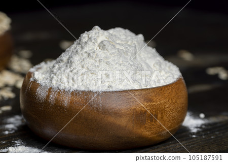 Wheat flour from a wooden bowl 105187591