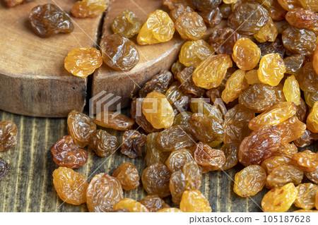 Dried yellow golden raisins on a board Dried yellow golden raisins on a board 105187628