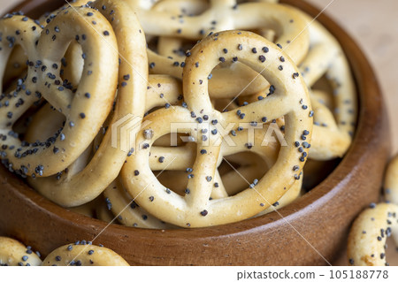 Poppy seed coating dried bagels on the table Poppy seed coating dried bagels on the table 105188778