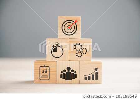 Wooden block cude step on table with Action Plan, Goal, and Target icons. Success and business target concept. Project management and company strategy symbolize growth. 105189549