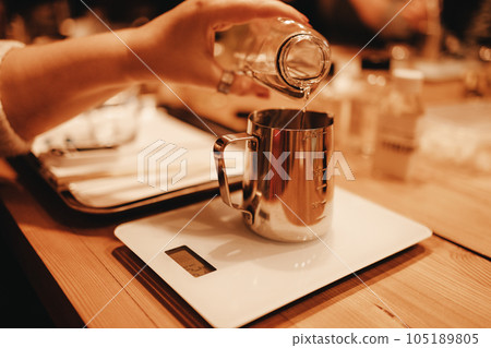 Pouring melted wax into glass. Set for crafting candle on metal tray Pouring melted wax into glass. Set for crafting candle on metal tray 105189805