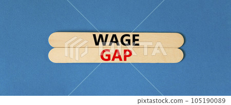 Wage gap symbol. Concept words Wage gap on beautiful wooden stick on a beautiful blue table blue background. Business, support and wage gap concept. Copy space. Wage gap symbol. Concept words Wage gap on beautiful wooden stick on a beautiful blue table blue background. Business, support and wage gap concept. Copy space. 105190089