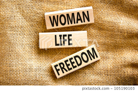 Woman life freedom symbol. Concept words Woman Life Freedom on wooden blocks on a beautiful canvas table canvas background. Social issue woman life freedom concept. Copy space. 105190103