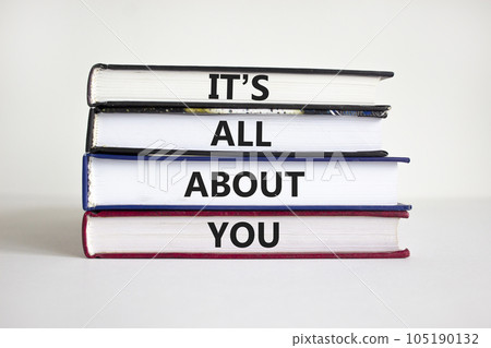 It is all about you symbol. Books with words 'It is all about you'. Beautiful white background. Businessman hand. Copy space. Business and it is all about you concept. 105190132