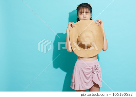 Blue background portrait of a young woman in a swimsuit Blue background portrait of a young woman in a swimsuit 105190582