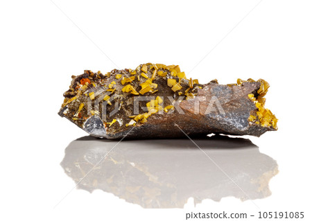 Macro mineral stone yellow Wulfenite on a white background 105191085