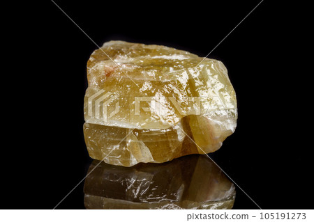 Macro mineral stone yellow Calcite on a black background 105191273