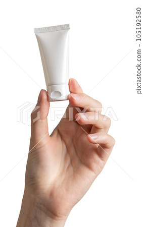 Hand holding small cream tube isolated white background Hand holding small cream tube isolated white background 105192580