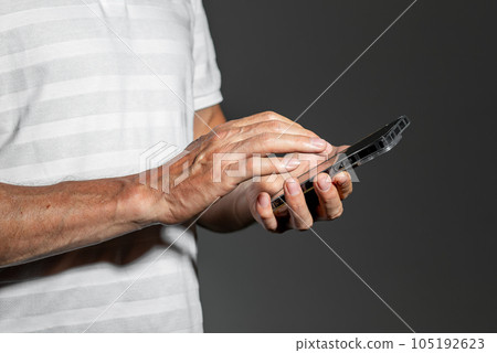 Hand holding mobile phone, scrolling, browsing online Hand holding mobile phone, scrolling, browsing online 105192623