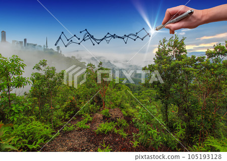 Hand drawing a growing graph on a mountain with cityscape in the background. 105193128