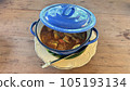 Thai style curry with fired egg in blue pot on wooden table. 105193134